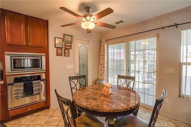 dining area featuring ceiling fan and light tile patterned floors