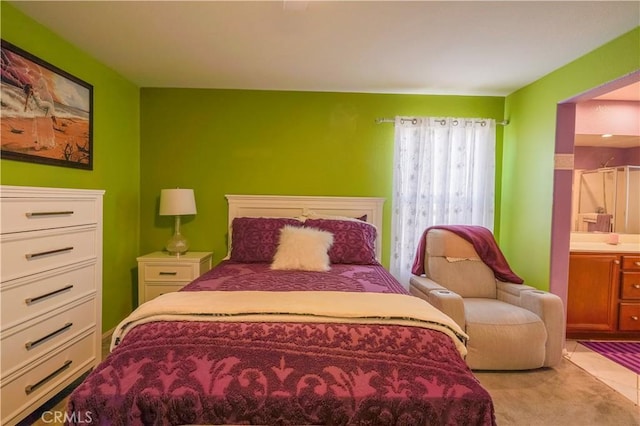 carpeted bedroom featuring ensuite bathroom