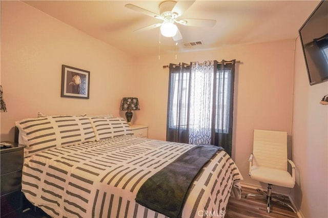 bedroom featuring ceiling fan and dark wood-type flooring