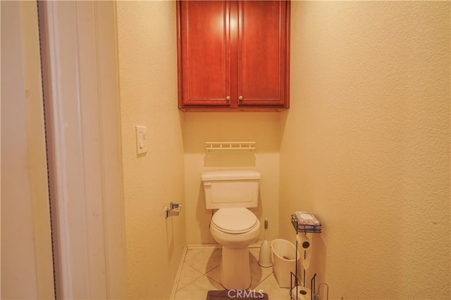 bathroom featuring toilet and tile patterned floors