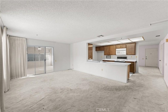 unfurnished living room featuring a textured ceiling and light carpet