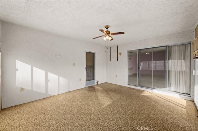 carpeted empty room with a textured ceiling, ceiling fan, and plenty of natural light