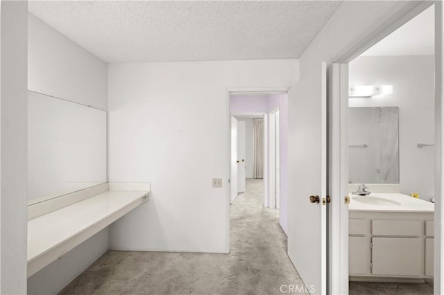 bathroom featuring a textured ceiling and vanity