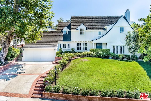 view of front of house featuring a garage and a front yard