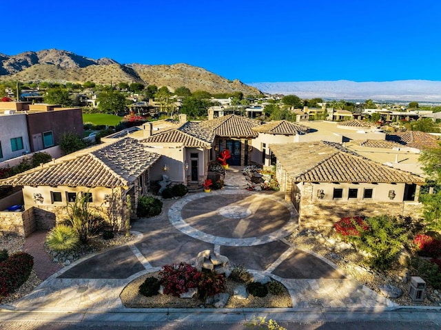 birds eye view of property with a mountain view