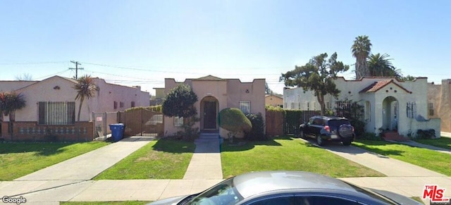 mediterranean / spanish-style house featuring a front lawn