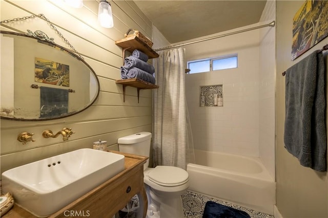 full bathroom with toilet, shower / bath combo, wood walls, and sink