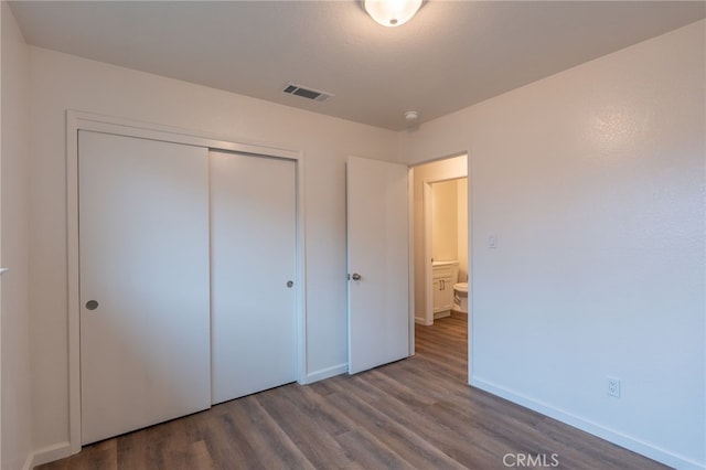 unfurnished bedroom featuring a closet and wood-type flooring