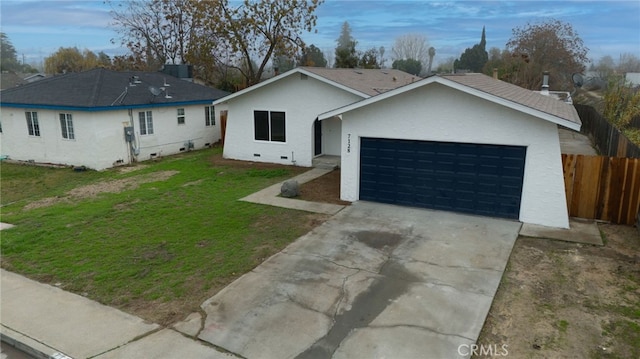 ranch-style home featuring a front lawn and a garage