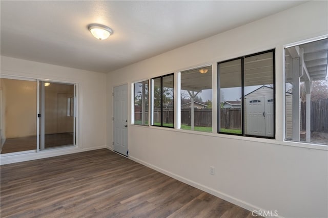 empty room with dark hardwood / wood-style floors