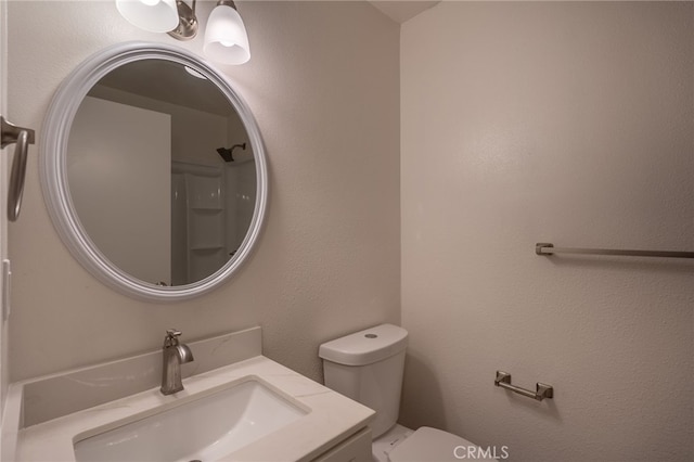 bathroom with toilet and vanity