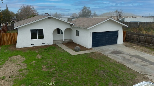 single story home featuring a garage and a front yard