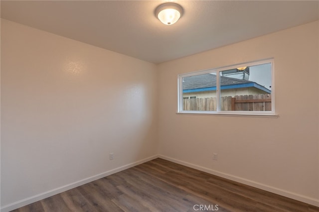 unfurnished room featuring dark hardwood / wood-style floors