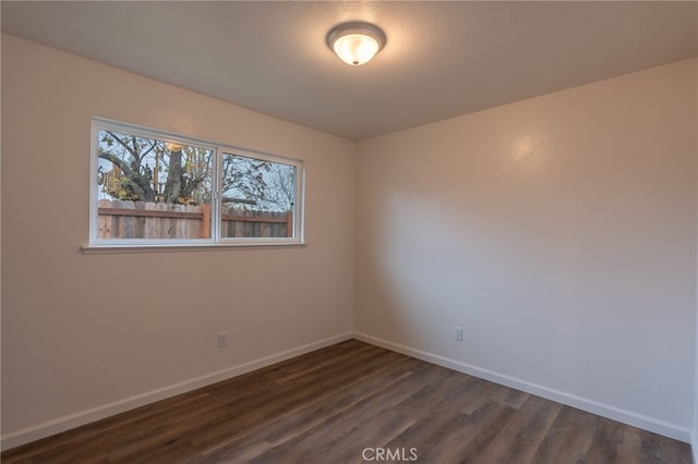 empty room with dark hardwood / wood-style floors