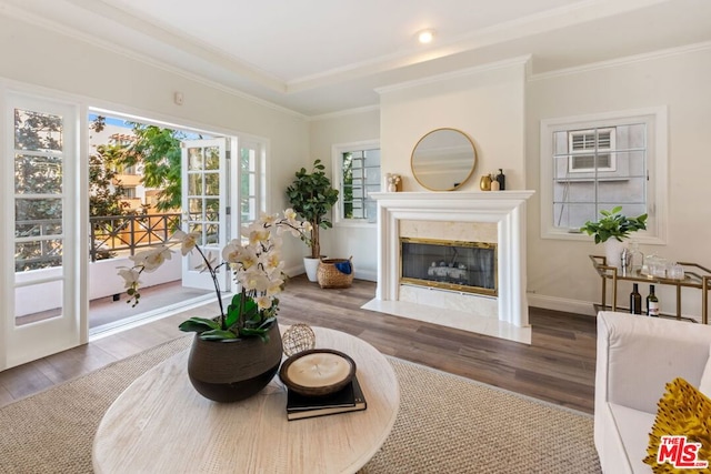 living room with ornamental molding, a high end fireplace, and dark hardwood / wood-style flooring