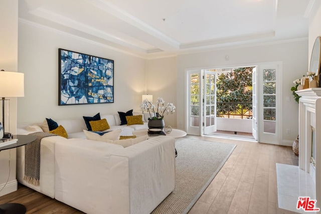 living room with crown molding and light hardwood / wood-style flooring