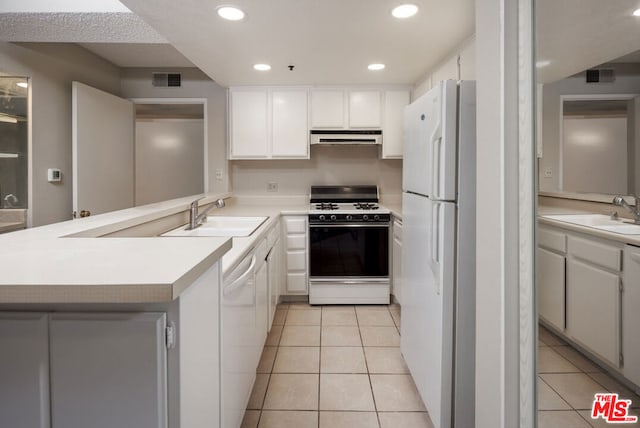 kitchen with sink, white cabinets, and white appliances