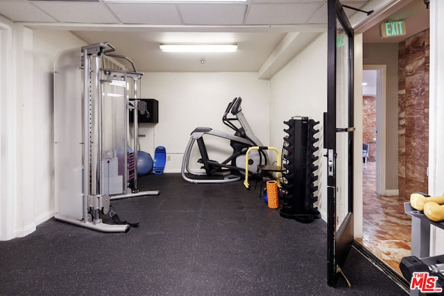 workout room with a paneled ceiling