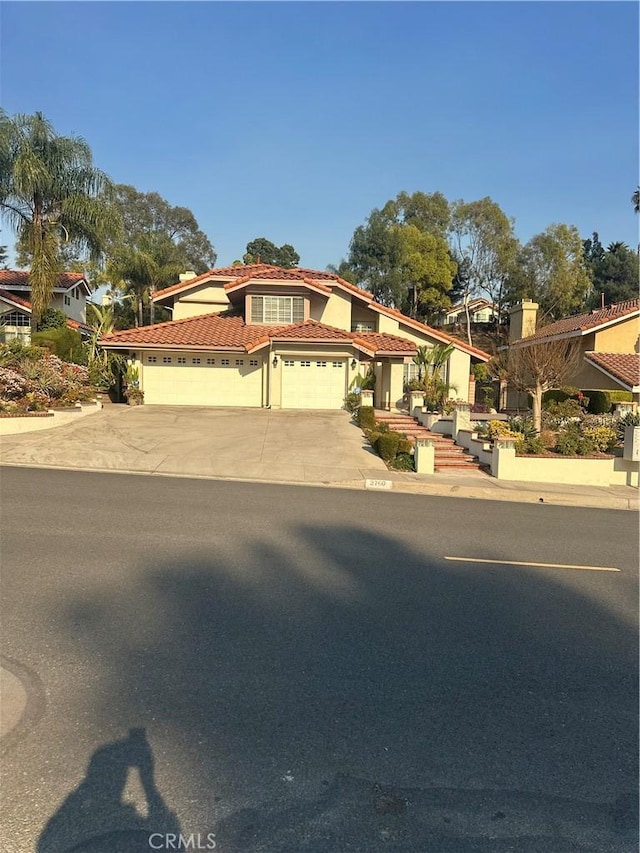 mediterranean / spanish-style house with a garage