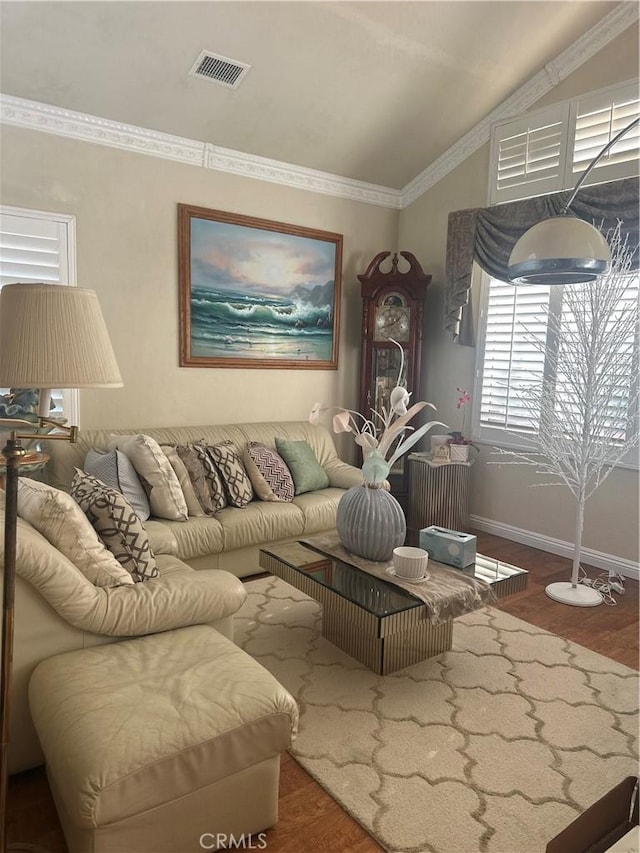 living room with lofted ceiling, ornamental molding, and hardwood / wood-style flooring