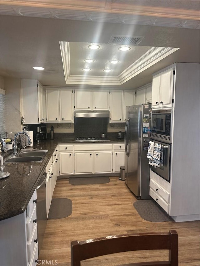 kitchen with white cabinets, appliances with stainless steel finishes, and sink