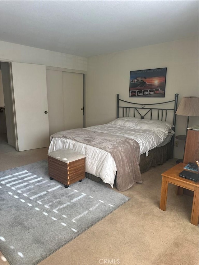 carpeted bedroom with a closet