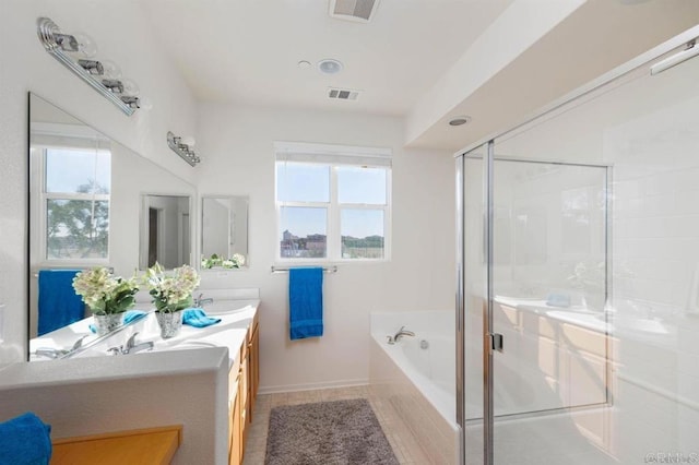 bathroom with plenty of natural light, vanity, separate shower and tub, and tile patterned flooring