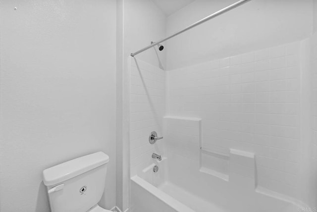 bathroom featuring toilet and bathing tub / shower combination