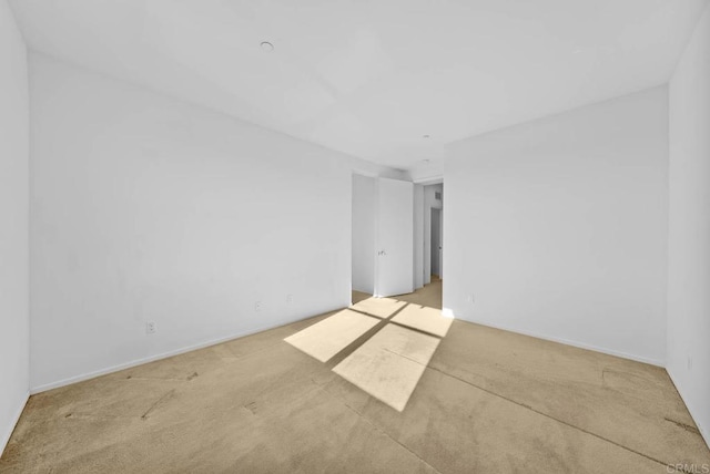 empty room with light colored carpet