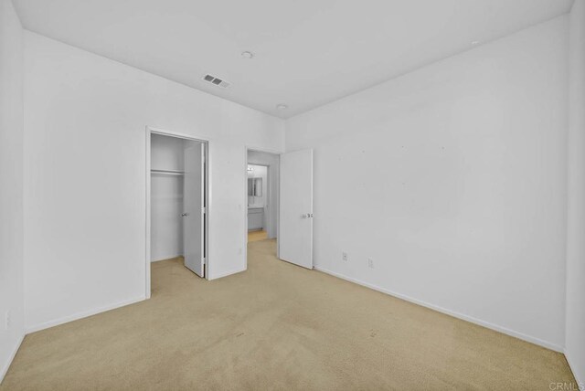 unfurnished room featuring light carpet