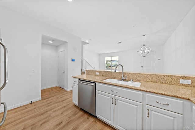 kitchen with decorative light fixtures, stainless steel dishwasher, sink, light wood-type flooring, and white cabinets