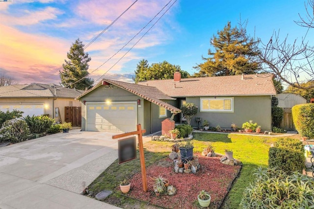 ranch-style home with a yard and a garage