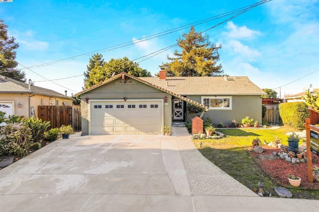 single story home with a front yard and a garage