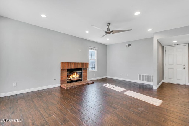 unfurnished living room featuring ceiling fan and a fireplace