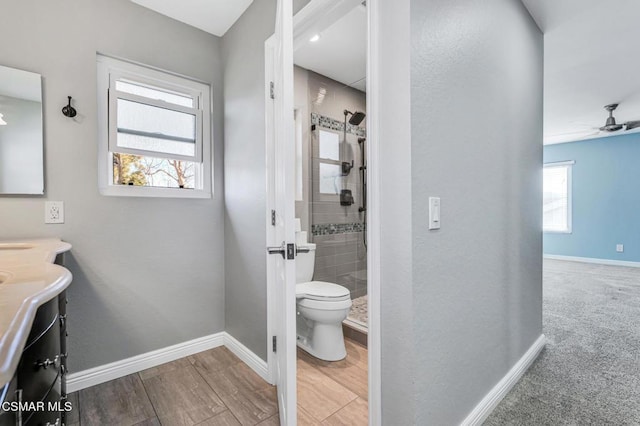 bathroom with ceiling fan, plenty of natural light, an enclosed shower, and vanity