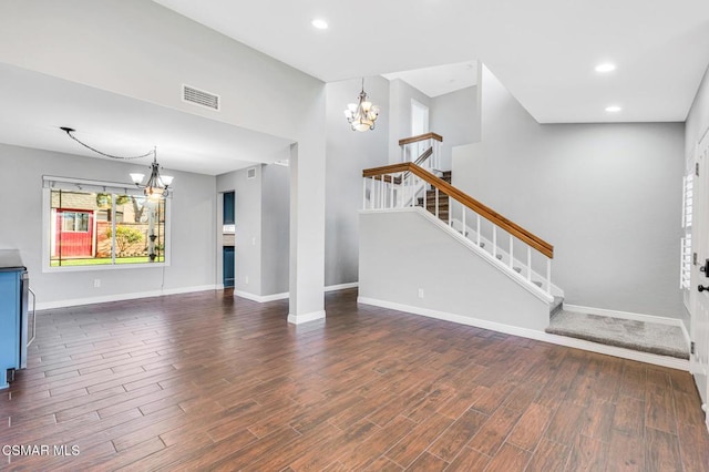 unfurnished living room with an inviting chandelier