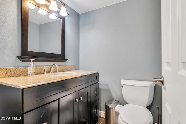 bathroom with toilet and vanity