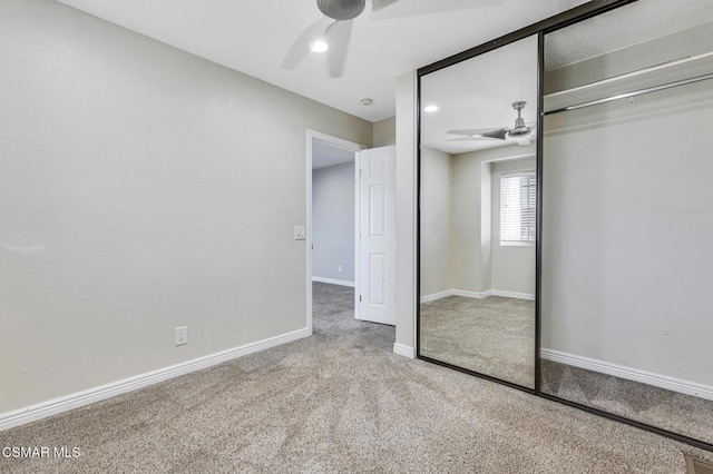 unfurnished bedroom featuring ceiling fan, carpet flooring, and a closet