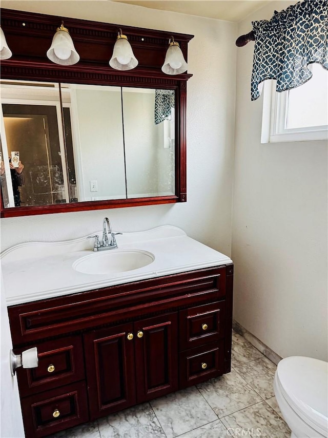 bathroom with toilet and vanity