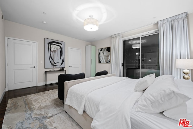 bedroom with wood-type flooring and access to outside