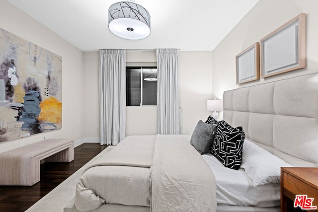 bedroom with dark hardwood / wood-style floors