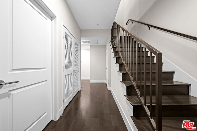 stairs featuring wood-type flooring