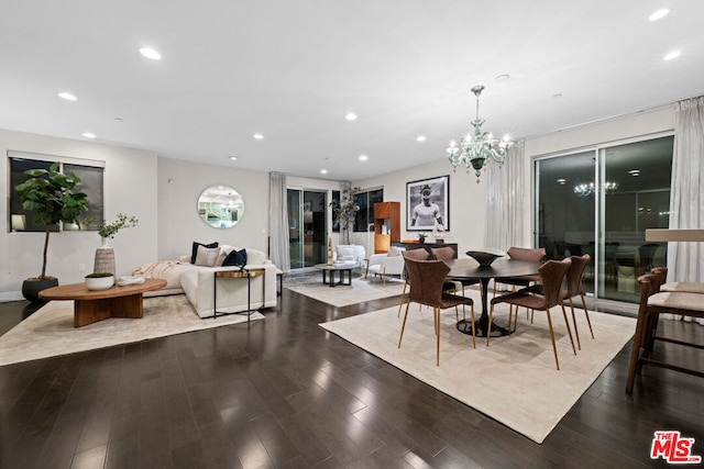 dining space featuring dark wood-type flooring and a notable chandelier