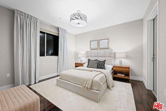 bedroom featuring dark wood-type flooring