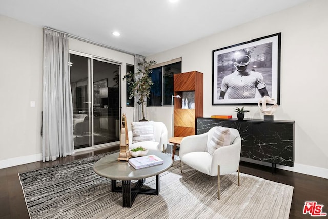 living area with hardwood / wood-style floors