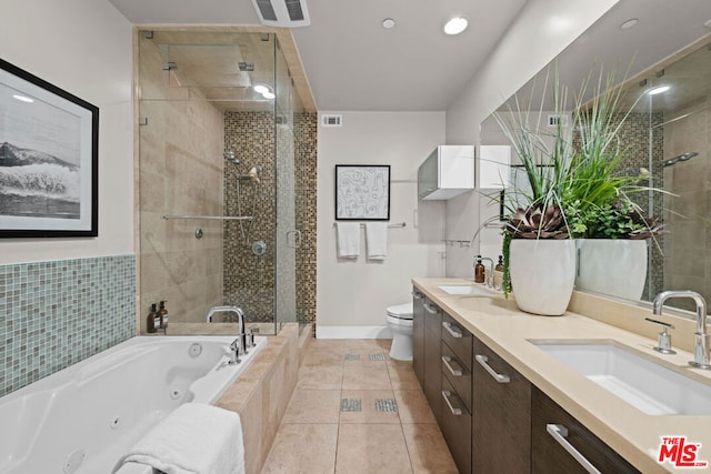 full bathroom featuring toilet, shower with separate bathtub, tile patterned floors, and vanity