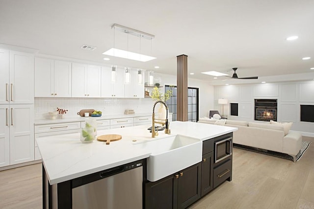 kitchen featuring ceiling fan, white cabinets, pendant lighting, and appliances with stainless steel finishes