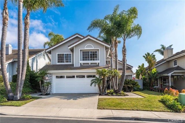 view of property with a front yard and a garage