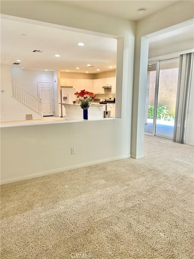 unfurnished living room featuring carpet floors