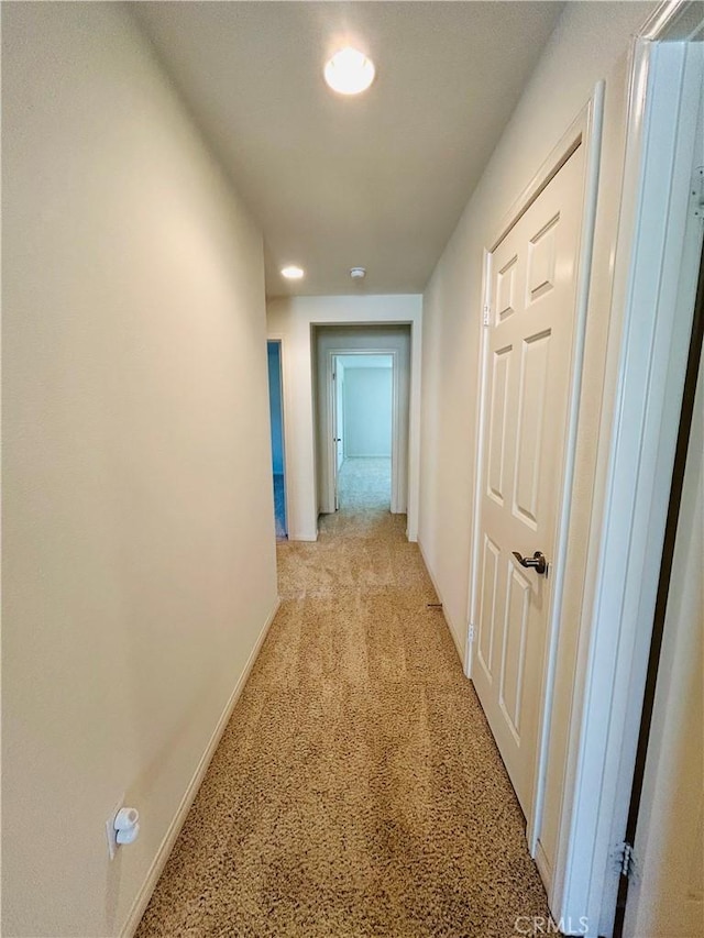 hall with light colored carpet